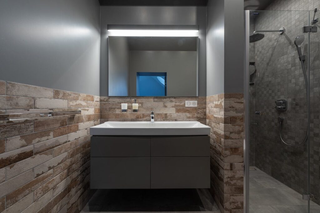 Crafting Captivating Headlines: Your awesome post title goes here Contemporary bathroom with a glass shower and illuminated mirror.